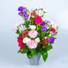 Facing Table Arrangement In Bright Colors Of Roses, Eustoma, Carnations And Berries